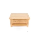 A light oak occasional table, the canted rectangular plank top, over a single frieze drawer,