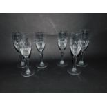 A set of six Dartington cut glass champagne flutes, with semi fluted and leaf engraved bowls, raised