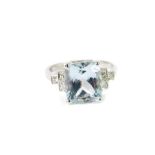 An 18ct white gold aquamarine and diamond ring, of high claw set stepped form, with rectangular