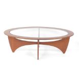 A G-Plan 1960's teak occasional table, the oval top inset with glass, raised on an X frame