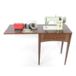 A Singer 319K automatic swing needle sewing machine, c1950's, pale green body, in a mahogany table