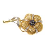An 18ct two colour gold sapphire and diamond brooch, formed as a multi petalled flower with a