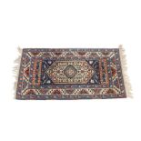 A Shiraz rug, decorated with floral and geometric motifs, against a cream and blue ground, 150cm x