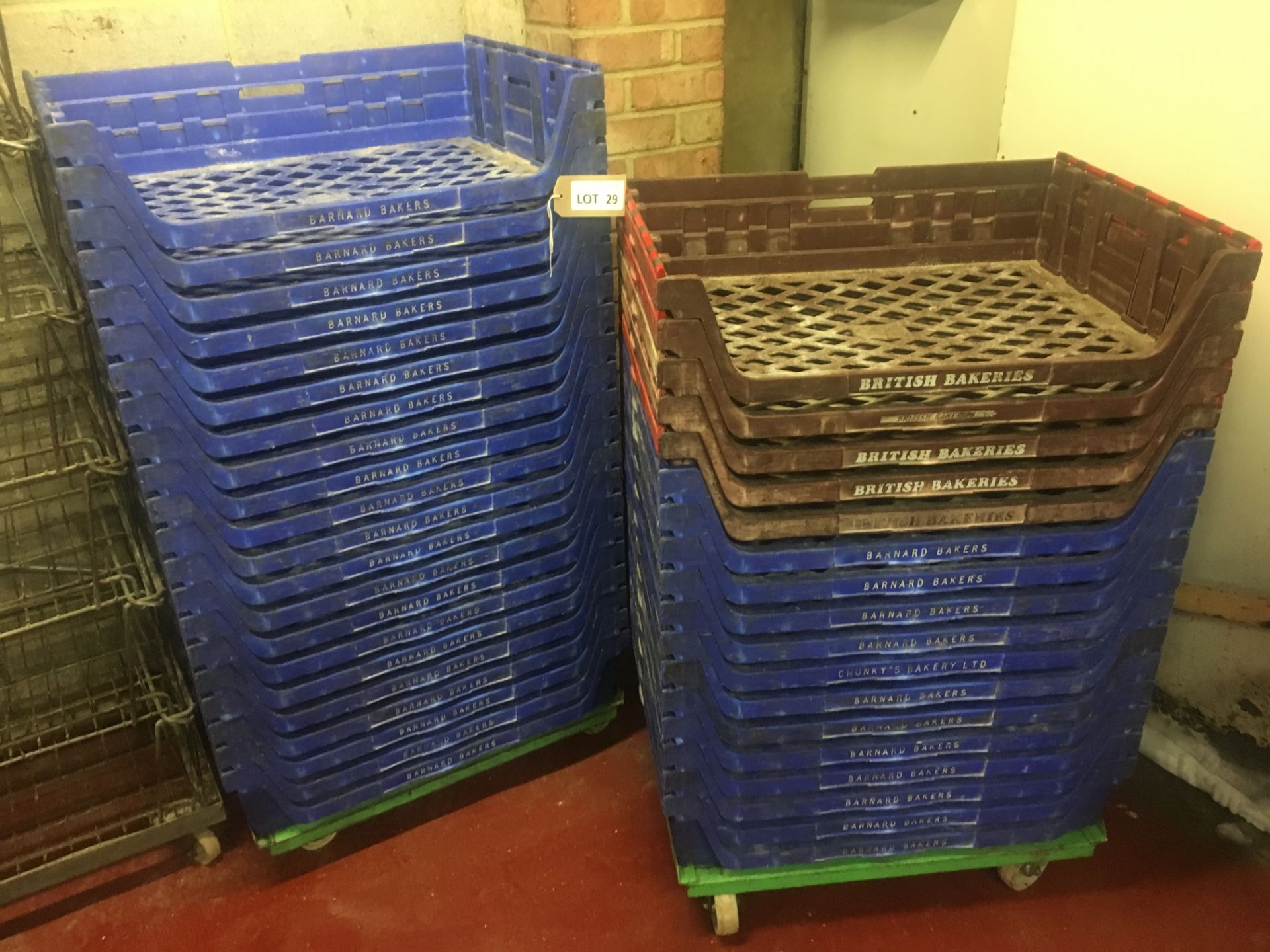 38 x blue stackable bread baskets branded ‘Barnard Bakers’ on 2 steel dollies