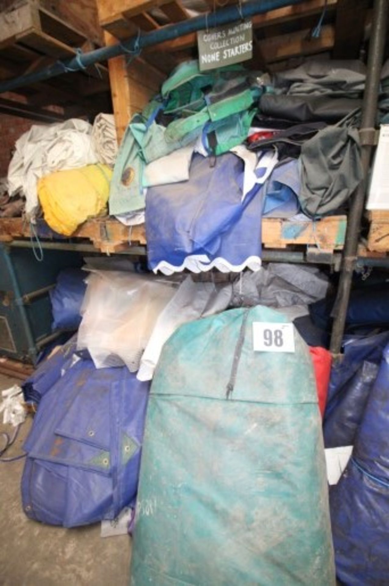 CONTENTS OF SHELF AND ON FLOOR OF RACK OF USED TARPAULIN SHEETS. (FORKLIFT CHARGE: £30.00 PLUS VAT)