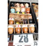 TRAY & CONTENTS OF 20 VARNISHED WOODEN PEDESTAL EGGS & CHARACTER PAINTED EGG CUPS.