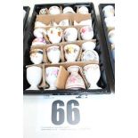 TRAY & CONTENTS OF 19 WHITE PAINTED & FLORAL PEDESTAL EGG CUPS.