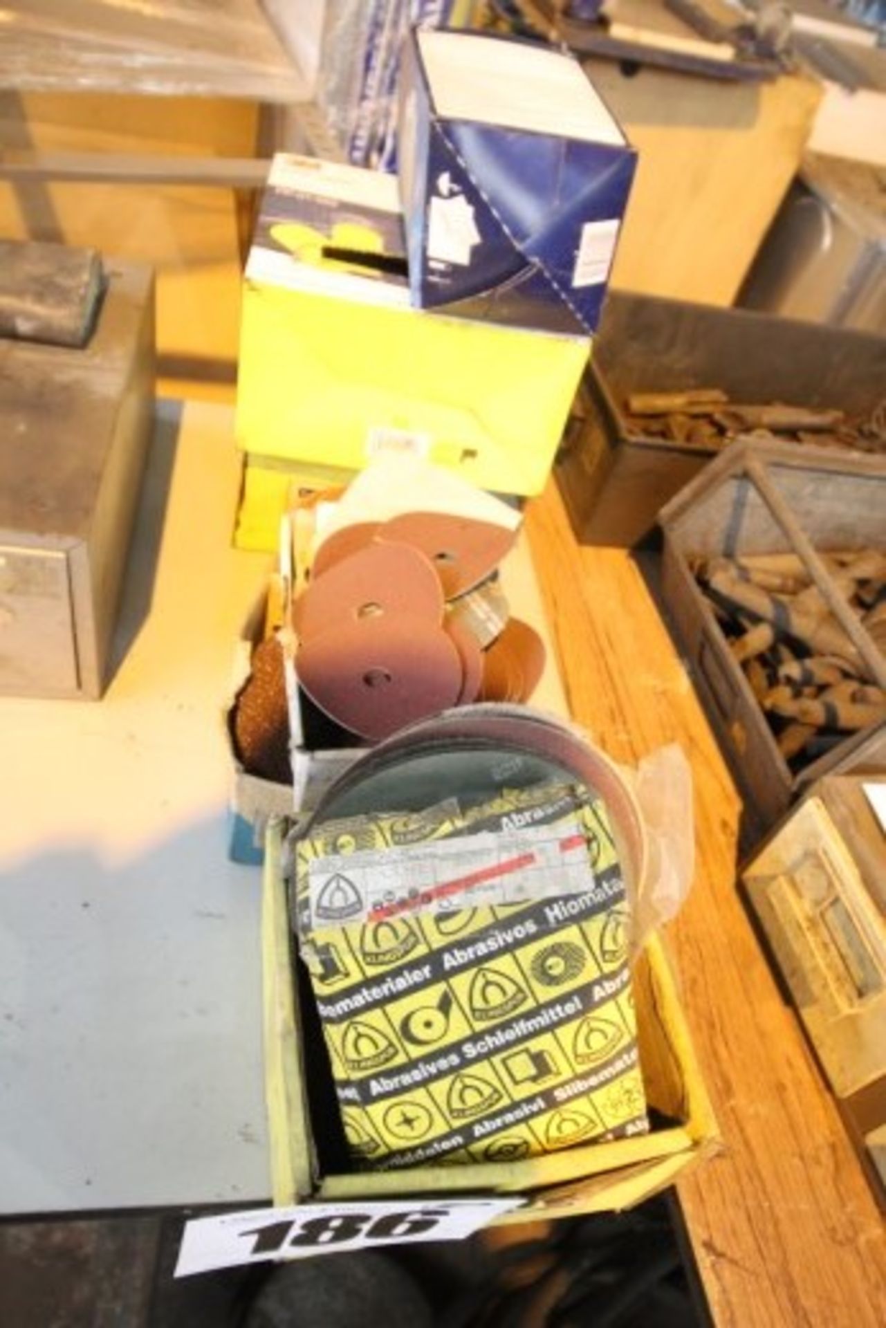 CONTENTS ON END OF TABLE OF VARIOUS ABRASIVE PAPER, EAR PLUGS, & FACE MASKS