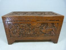 Heavily carved hardwood trunk