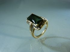 Hand crafted gold ring set with large Green Emerald cut Tourmaline and channel set diamonds to