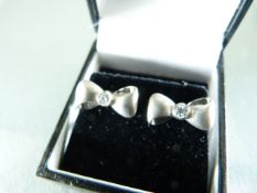 Pair of white gold and diamond set earrings in the form of bow ties