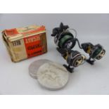 Vintage fishing reels to include three Intrepids by K.P Morrits, along with two Gut case boxes,