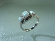 Silver (S925) ring with CZ and three opals
