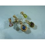 Five gold pendants - To include a 15ct paste set pendant, Poss Emerald and Ruby set pendant,
