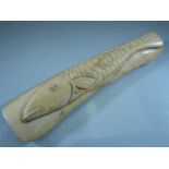 Scrimshaw - A piece of bone carved with a simple single fish.