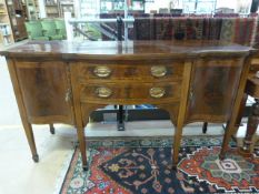 Edwardian mahogany sideboard on Tapering legs with inlay to cupboards, drawers and top.