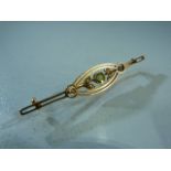 Unmarked Gold (poss 15ct) Edwardian bar brooch set with central Peridot and seed pearls. Approx