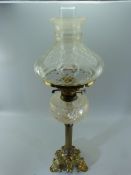 Unusual glass and brass oil lamp with Corinthian type column to Rococo style footing. Twin burner.