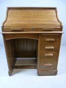 The Lebus Desk in Oak with 4 drawers to one side and Pigeon holes housed under the Tamber Roller
