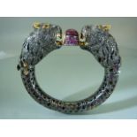 White metal (Silver?) bangle in the form of a double Panther head guarding a central approx. 15/16