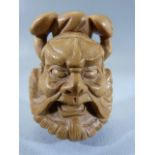 Japanese Carved wooden Netsuke - depicting a mans face. Marked to back