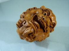Carved wooden netsuke in the form of a dragon, signed to the base