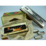 Oversized Hohner Harmonica, three miniature and one other called Echo-Luxe