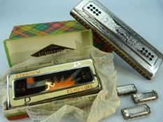 Oversized Hohner Harmonica, three miniature and one other called Echo-Luxe