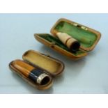 Two Cheroot/ cigarette holders with amber and silver both cased