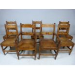 Set of seven Arts and Crafts planked oak chairs to include two carvers