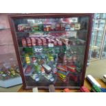 Large collection of collectable model buses '00' gauge presented in a glass fronted cabinet.