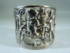 Silver (800) unusual napkin ring with pierced work design. Decorated with Cherubs and a central