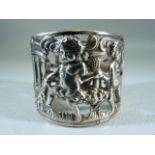 Silver (800) unusual napkin ring with pierced work design. Decorated with Cherubs and a central