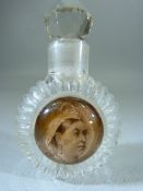 Victorian glass scent bottle with Queen Victoria bust to front. With Faceted glass ball stopper
