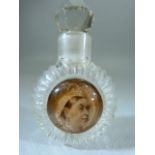 Victorian glass scent bottle with Queen Victoria bust to front. With Faceted glass ball stopper