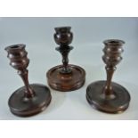 Carved wooden candlesticks - 1 pair and another.