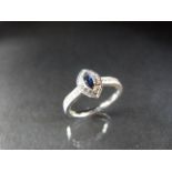 18ct White Gold Diamond ring set with an oval Sapphire