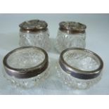 Four hallmarked silver topped and banded dressing table jars