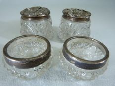 Four hallmarked silver topped and banded dressing table jars