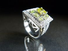 White Gold Diamond ring with central princess cut Yellow Diamond flanked with Eight Brilliant cut