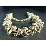 Gold coloured bracelet set with open work panels of roses