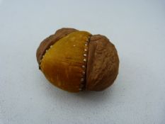 Walnut in the form of a pin cushion