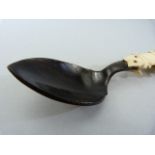 Inuit - carved bone utensil. Made up from Spoon, fork and pick. The spoon dark horn/stained bone,