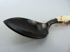 Inuit - carved bone utensil. Made up from Spoon, fork and pick. The spoon dark horn/stained bone,