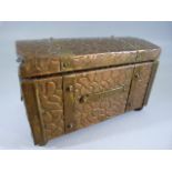 Unusual copper over wood tea chest bound with brass and raised on brass feet.