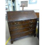 Antique oak bureau with drawers and pigeon holes inside.