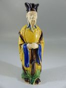 Oriental figure of a mud man - glazed in blue ochre and green.