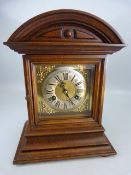 Oak dome topped mantle clock with bevel glass front