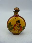 Unusual oriental snuff bottle of enamel over metal. The circular bodied bottle with two enamelled