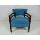 Blue open armchair on darkwood legs